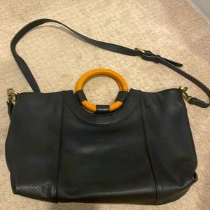 Anthropologie purse with wooden handles.